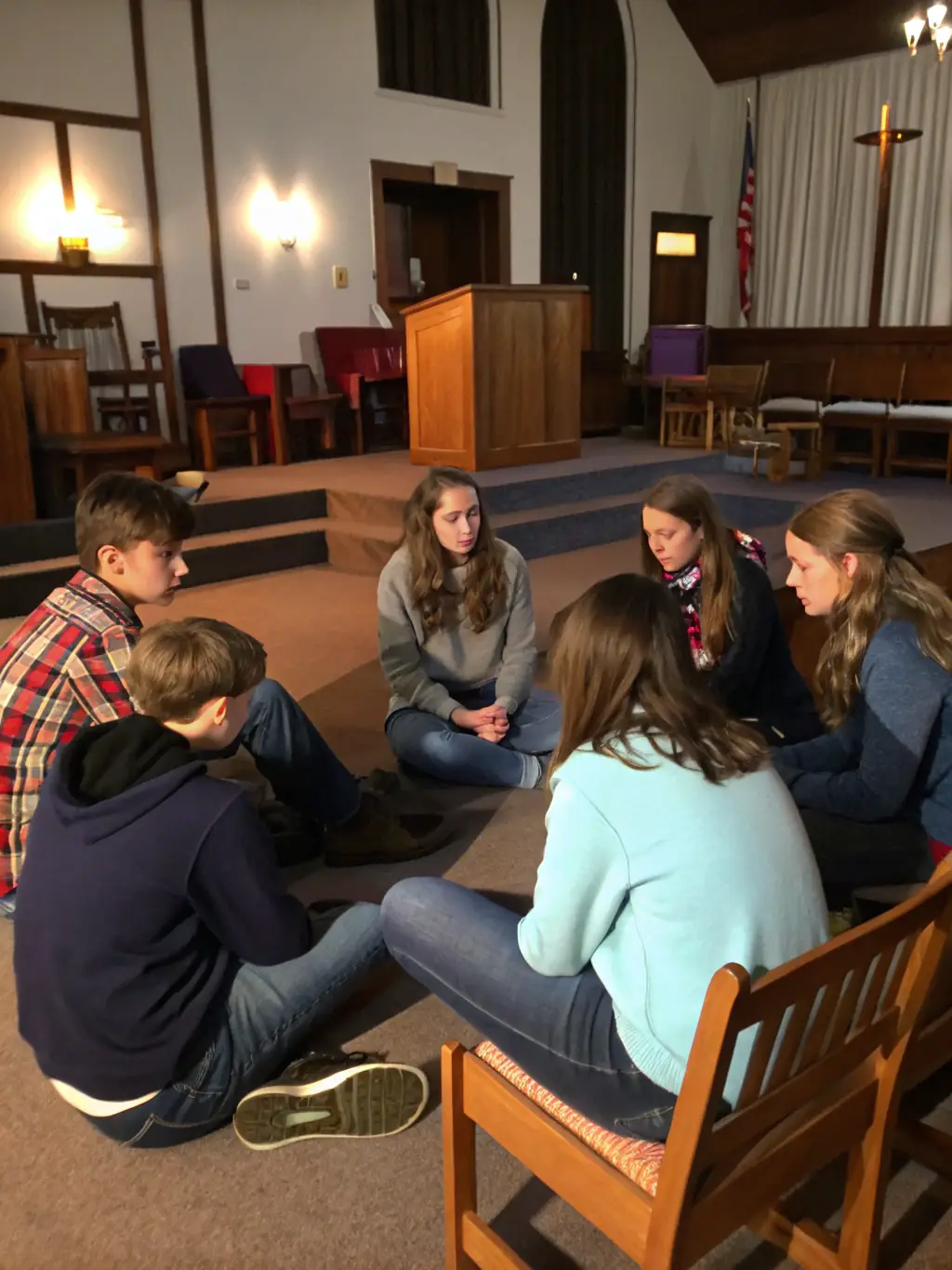 A serene image of a diverse group of people engaged in a religious discussion, symbolizing enhanced understanding of Catholic faith and traditions within the FRATERNITE SACERDOTALE SAINT-PIE X.